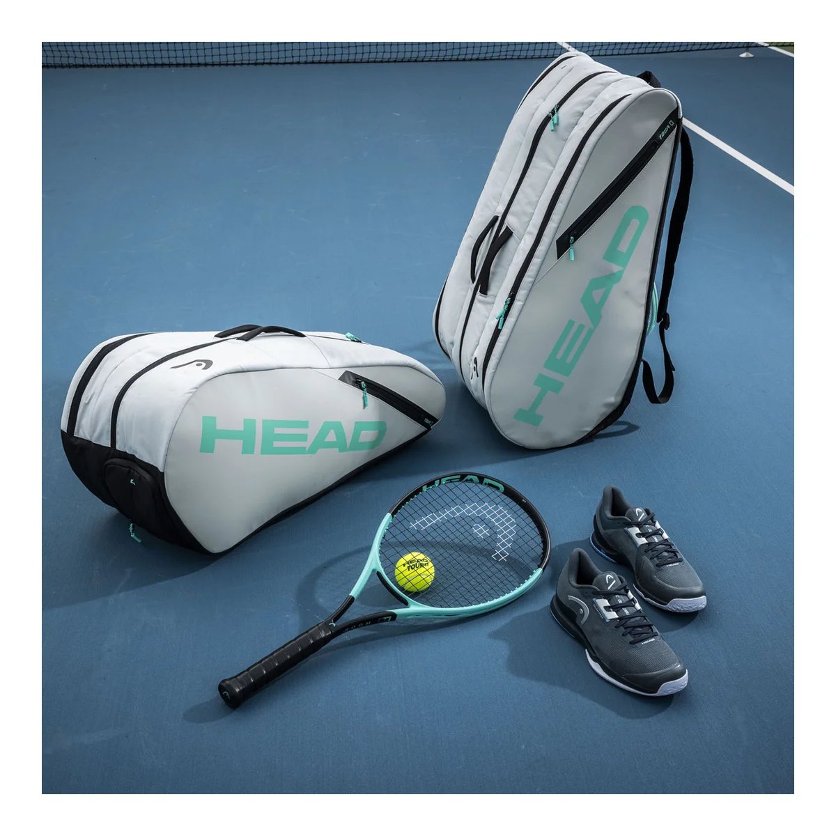 Tennis racket HEAD Boom Team L 2024 with tennis bag and tennis gear on the court
