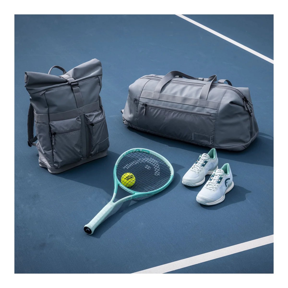 Tennis racket HEAD Boom MP Alternate 2024 on court with tennis gear, backpack and sports bag for training