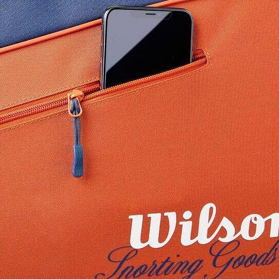 Термобег Wilson Team Roland Garros 2026 - 3 ракети в оранжево, с външен джоб с цип и място за телефон